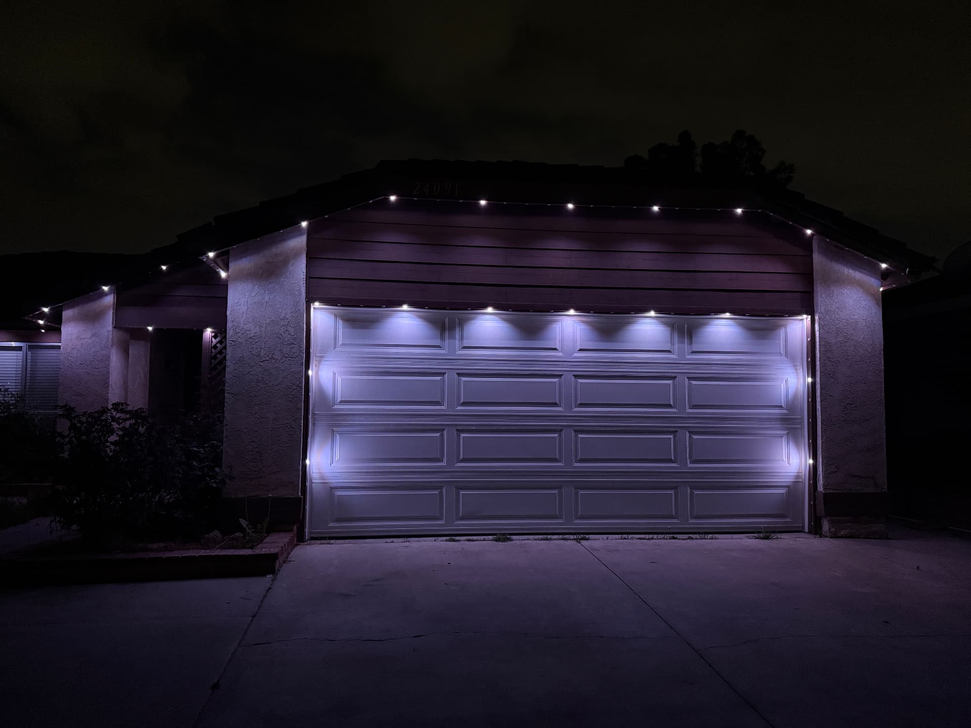 Dimmed cool white architectural lighting on a garage