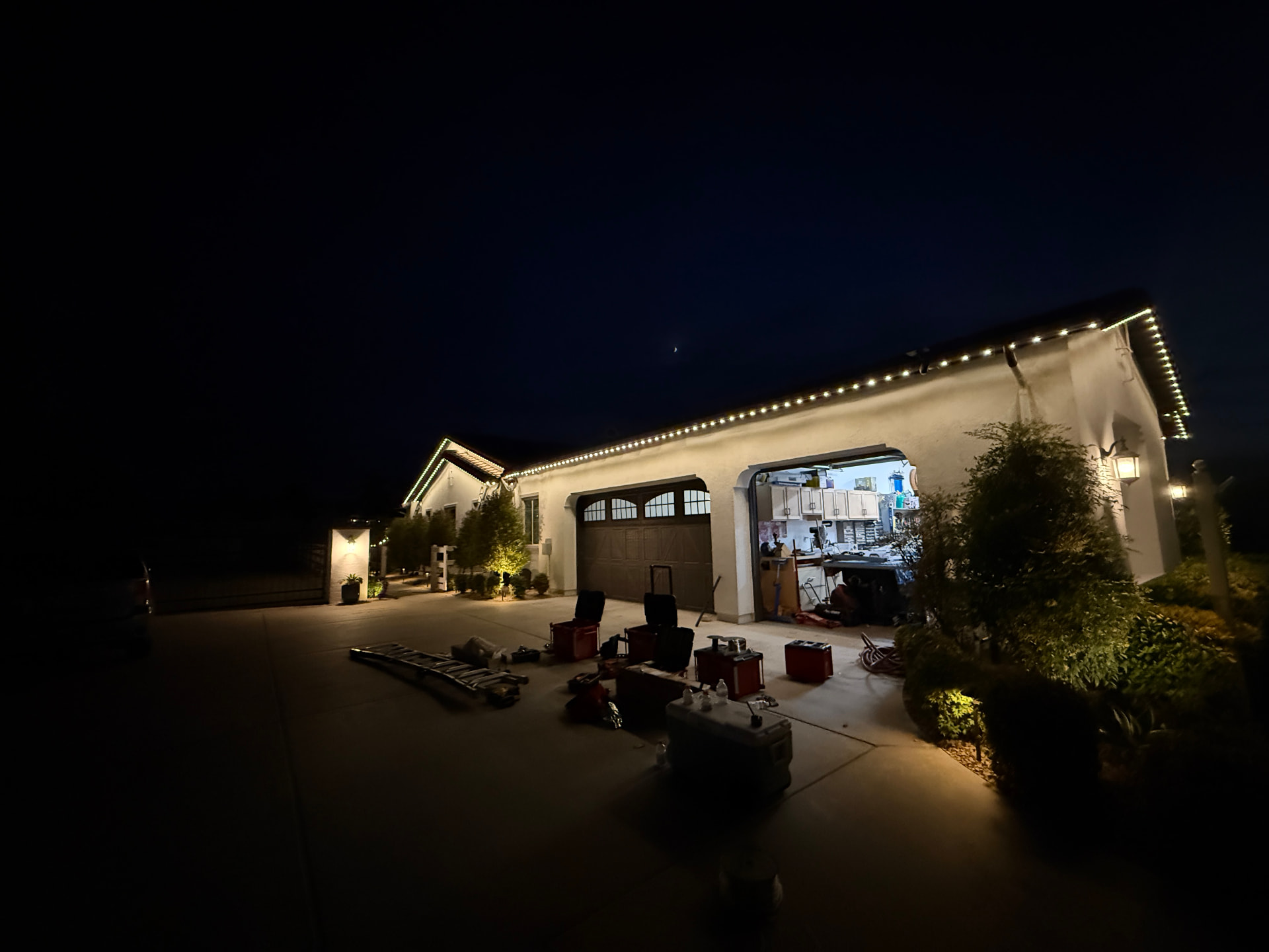 Warm permanent lighting along a long residential roofline
